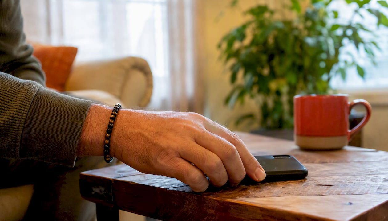 Hand tapping wrist bracelet as habit cue