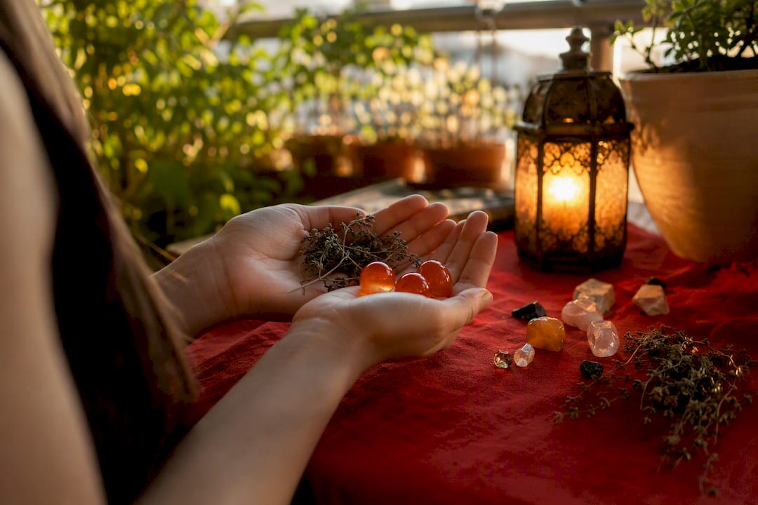 Hands holding marbles and herbs for sensory visualization