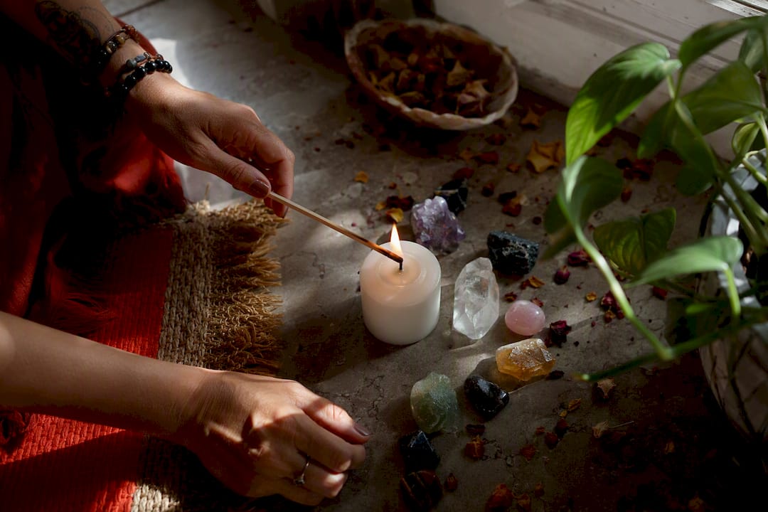 Hands lighting candle for ritual